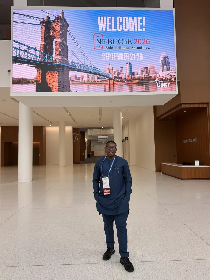 Conference attendee beneath a NOBCChE 2026 welcome display